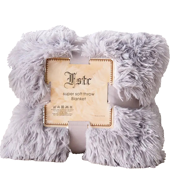 Fluffy gray throw blanket with a brand label on a light background