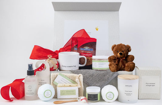 Gift set with a mug, teddy bear, and various items on a white background