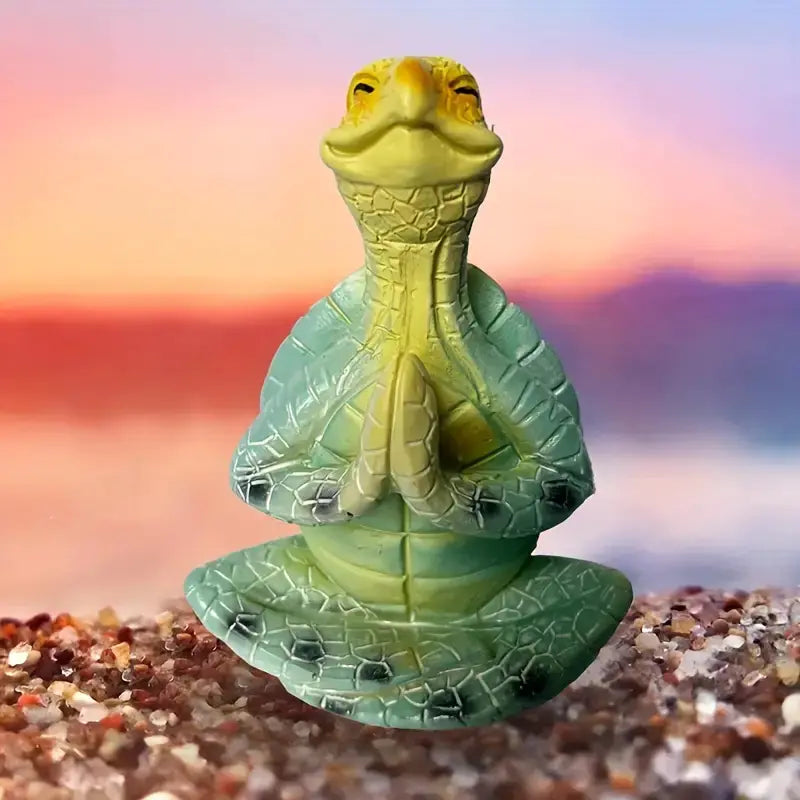 Green and yellow lizard-like figurine on a beach with a colorful sky background
