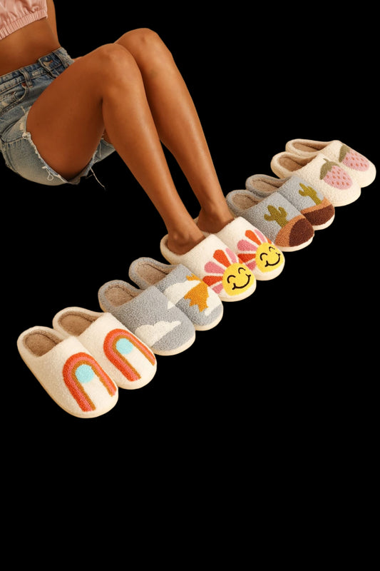 Colorful slippers with cartoon designs on a beige background