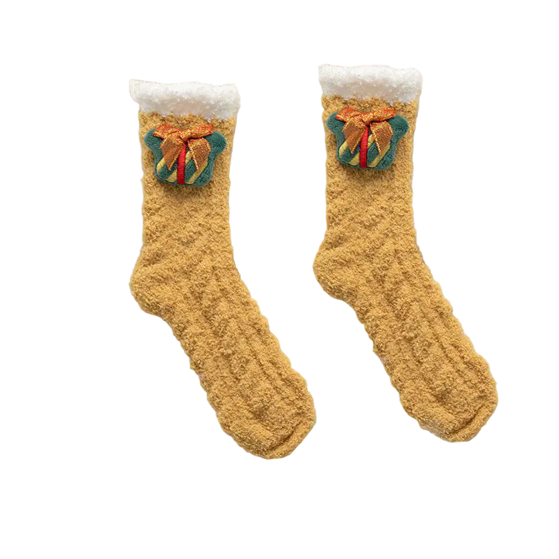 Pair of mustard yellow socks with green and red accents on a white fluffy surface