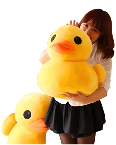 Person holding a large yellow plush duck toy in a room with patterned wallpaper.
