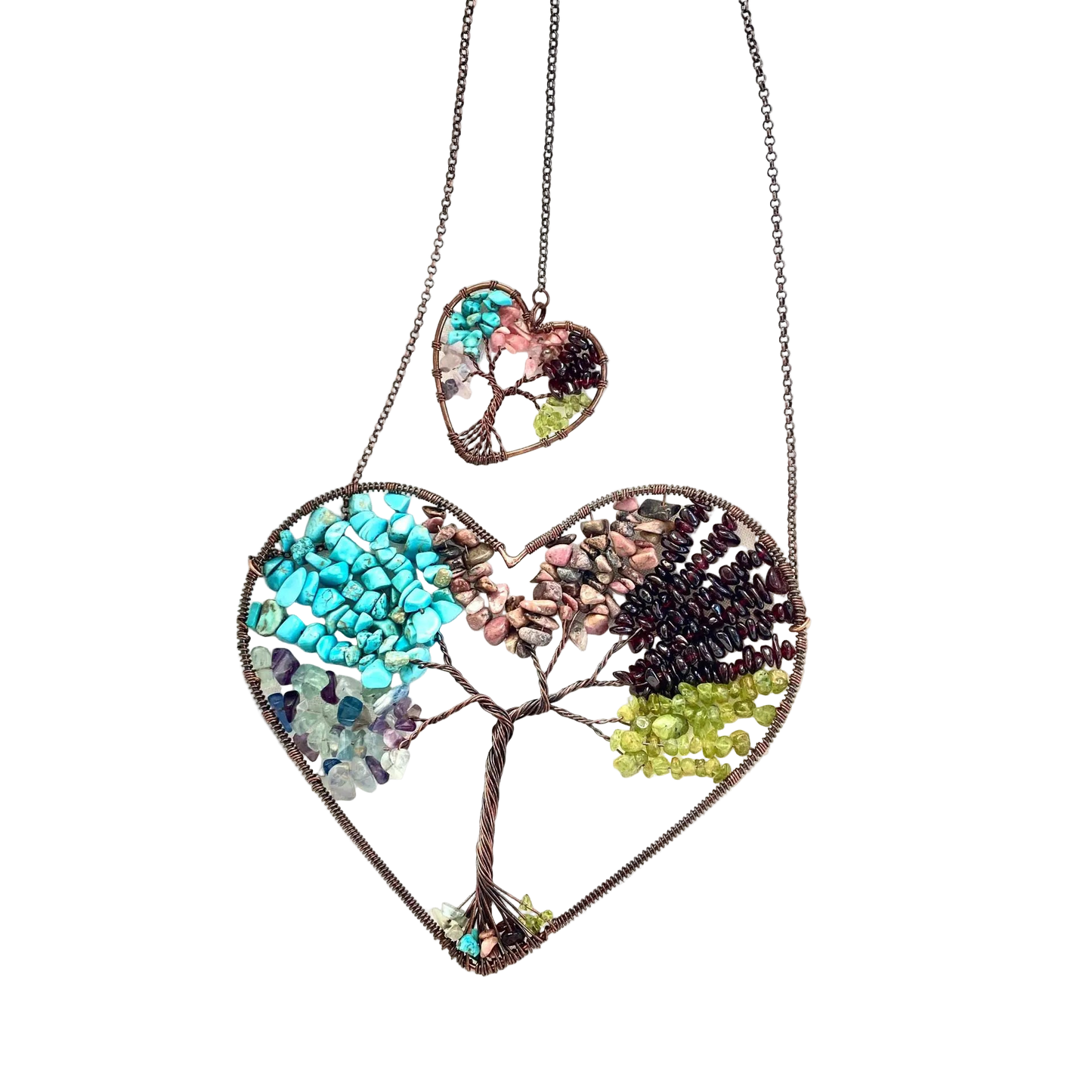 Heart-shaped necklace with a tree design on a white fabric background