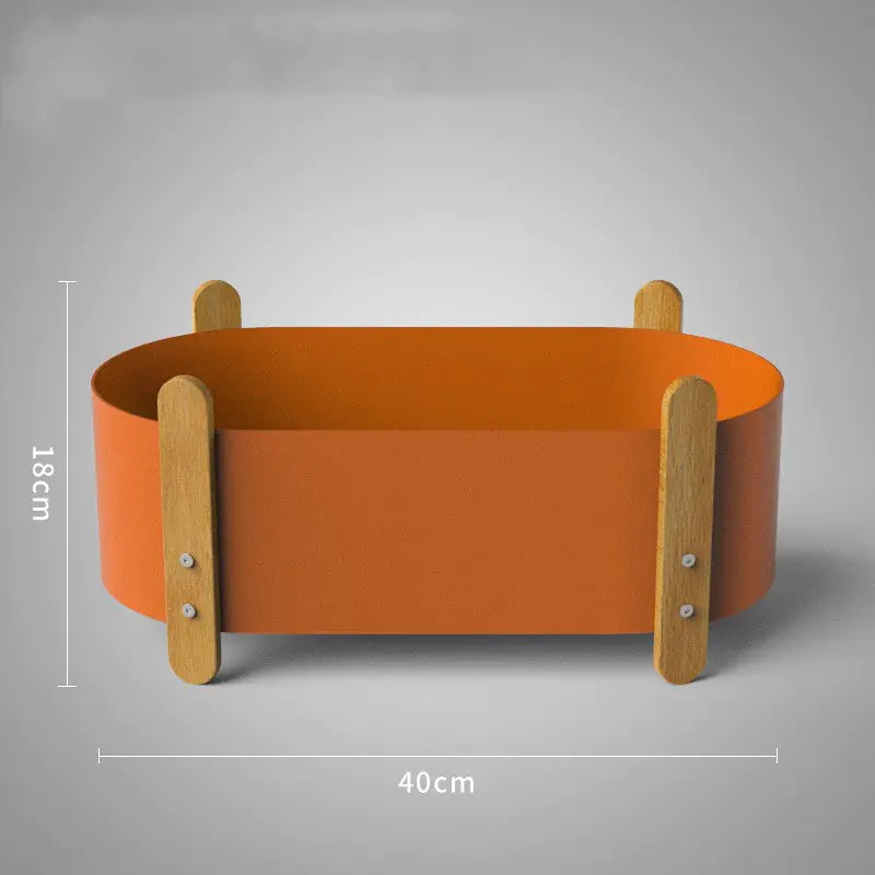 Orange round container with wooden handles and dimensions on a gray background
