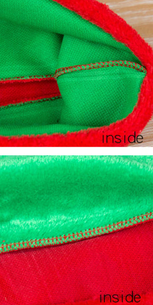 Green and red striped hat with close-up of inside stitching on a white background