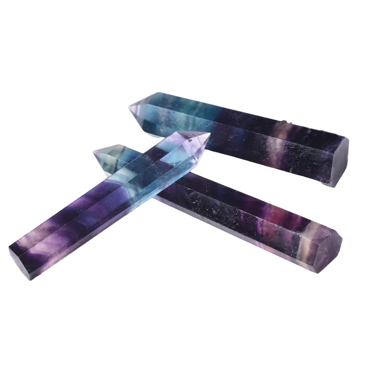 Multicolored crystal sticks on a white surface with text overlay