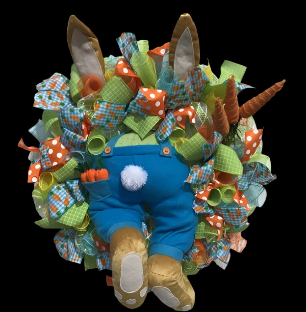 Colorful wreath with a cartoon character in blue overalls on a white door.