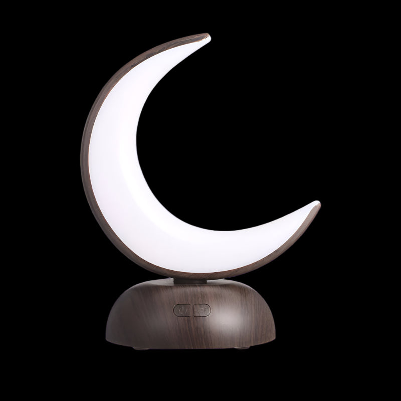 Moon-shaped lamp with wooden base on a white background