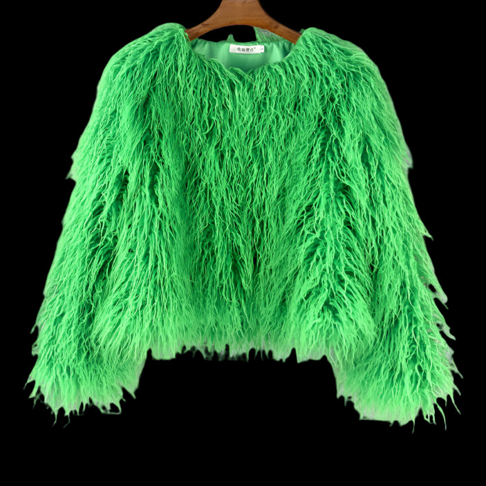 Green fluffy jacket on a hanger against a gray wooden panel background