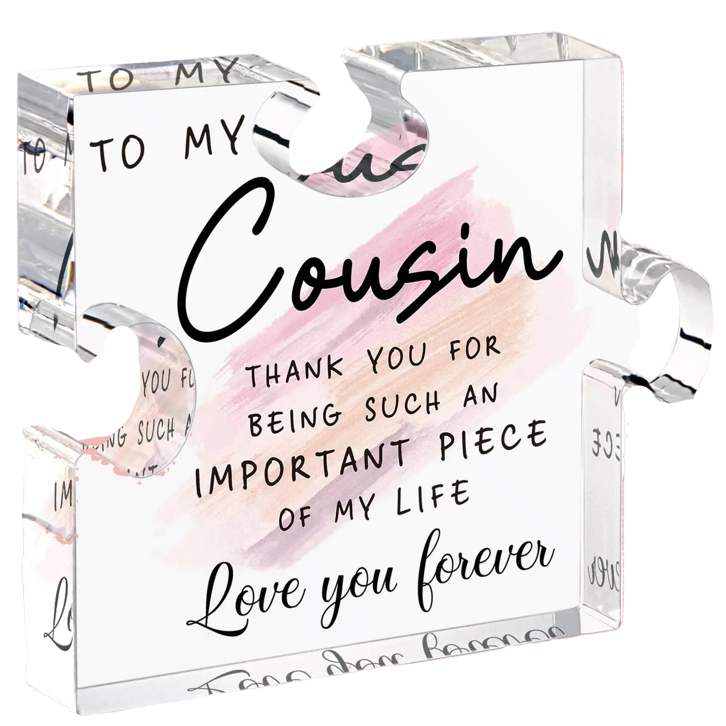 Clear glass block with engraved message to a cousin on a white background