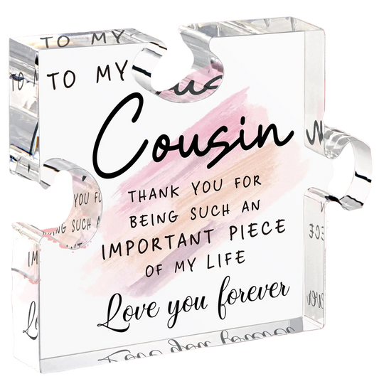 Clear glass block with engraved message to a cousin on a white background
