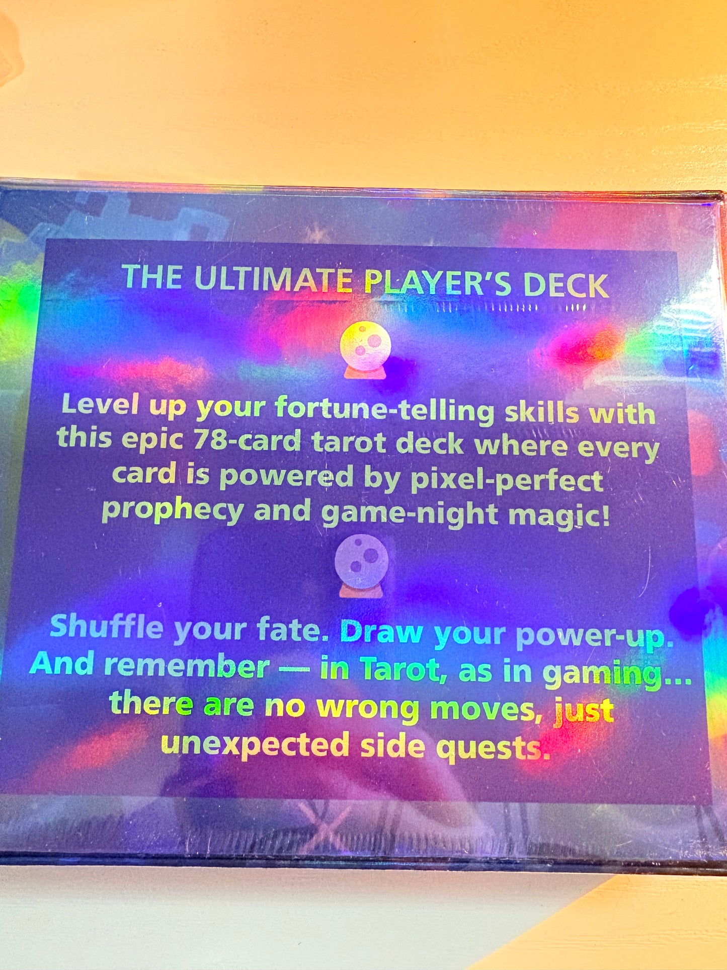 Holographic card packaging with text about 'The Ultimate Player's Deck' on a gradient background.