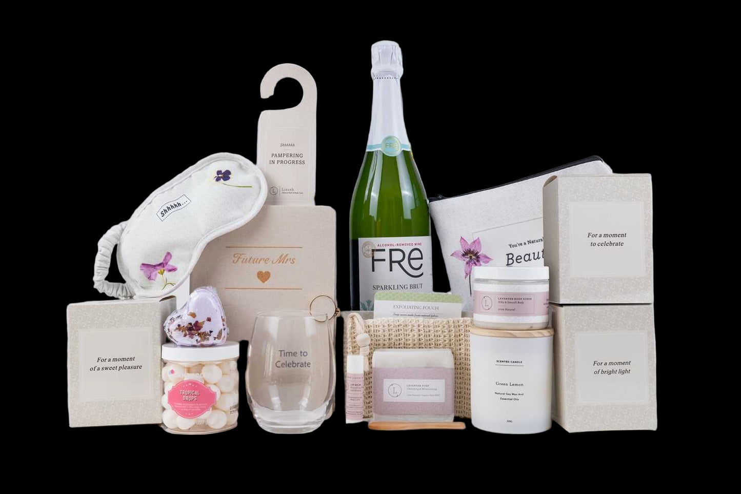 Collection of beauty products including a bottle of Fre, candles, and other items on a white background