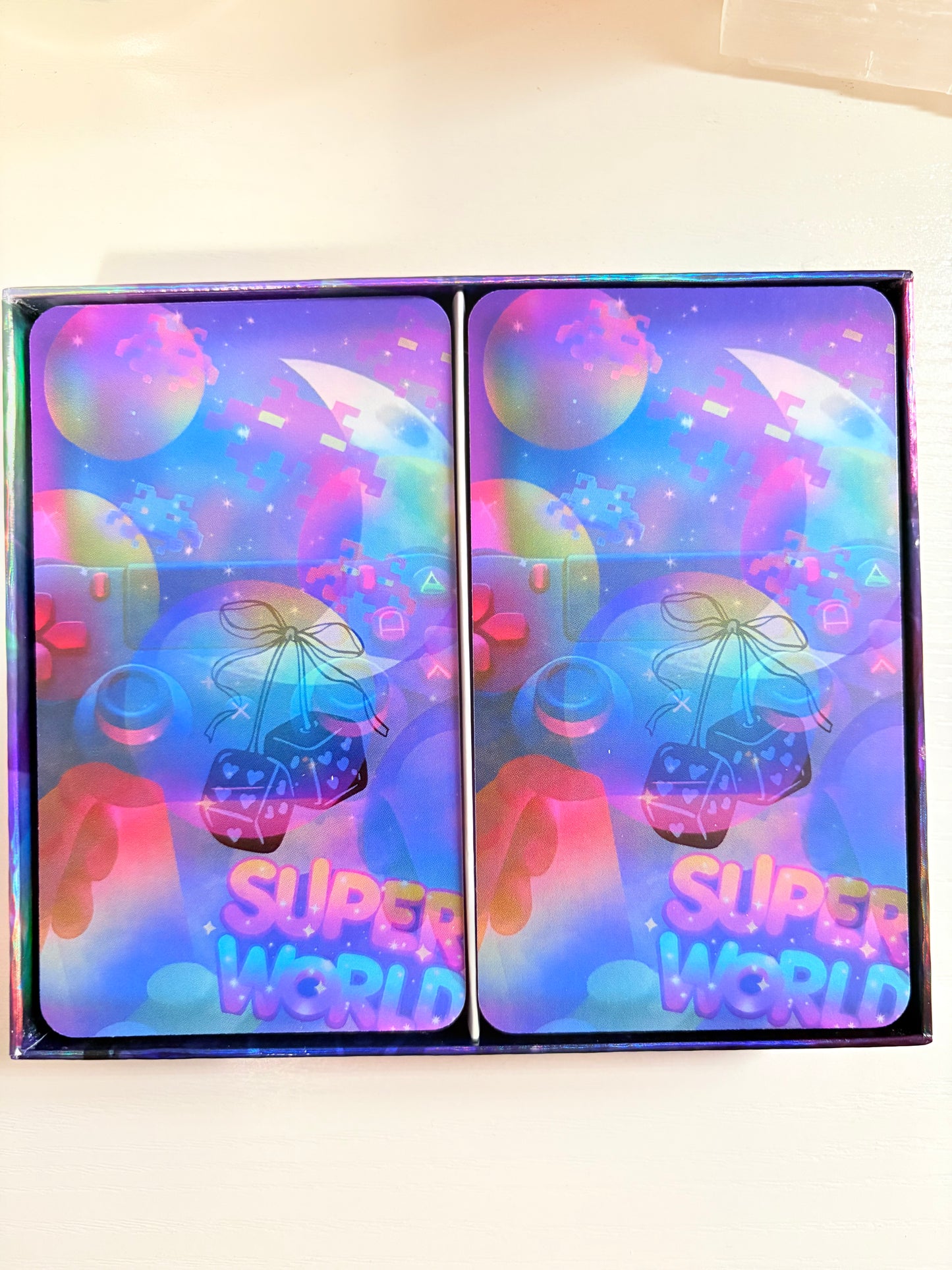 Colorful holographic packaging with 'Super World' branding on a white background