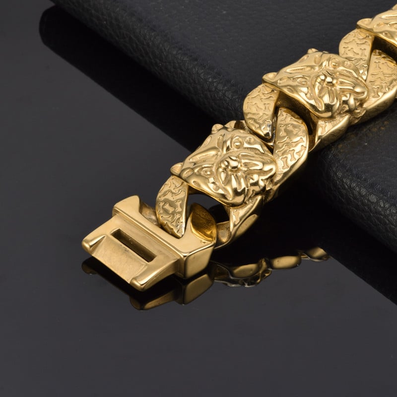 Gold bracelet with a lion head design on a black background