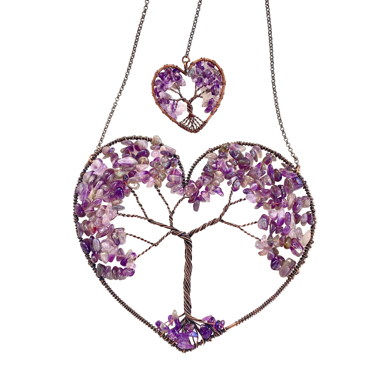 Heart-shaped jewelry with tree design made of purple stones on a white background