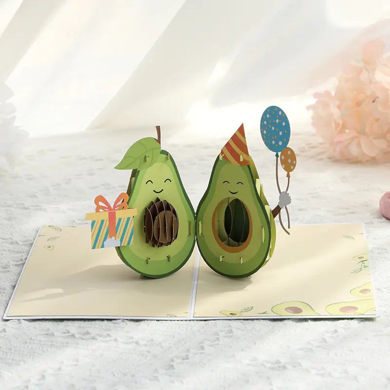 Pop-up card with avocado characters on a white background