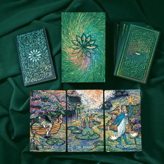 Set of tarot cards with intricate designs on a dark green fabric background