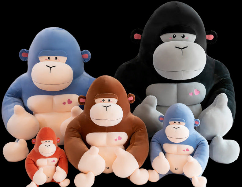 Set of colorful monkey plush toys on a light background