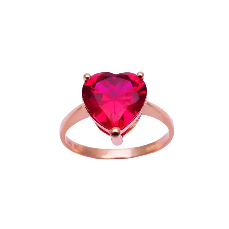 Rose gold ring with a heart-shaped red gemstone on a light purple background