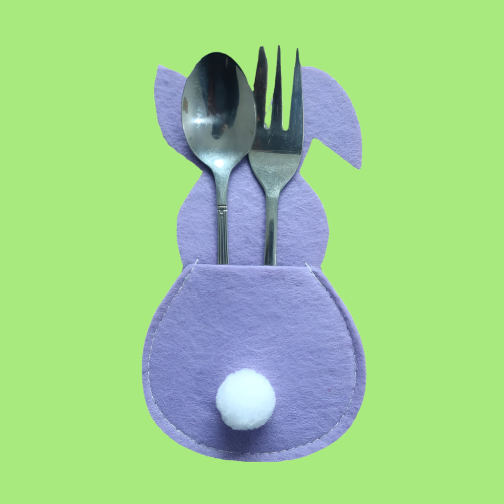 Purple cat-shaped cutlery holder with a spoon and fork on a white background