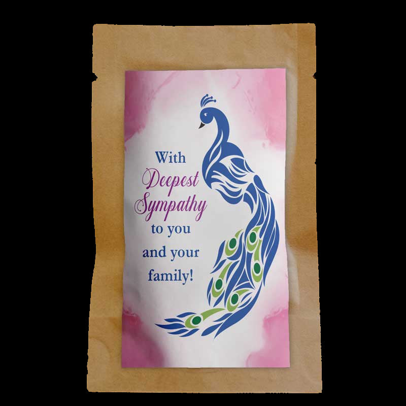 Greeting card with peacock design and text on a wooden surface