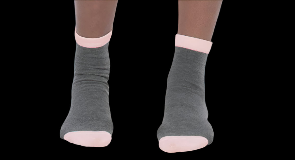 Gray ankle socks with pink toes and cuffs worn by a person on a white background