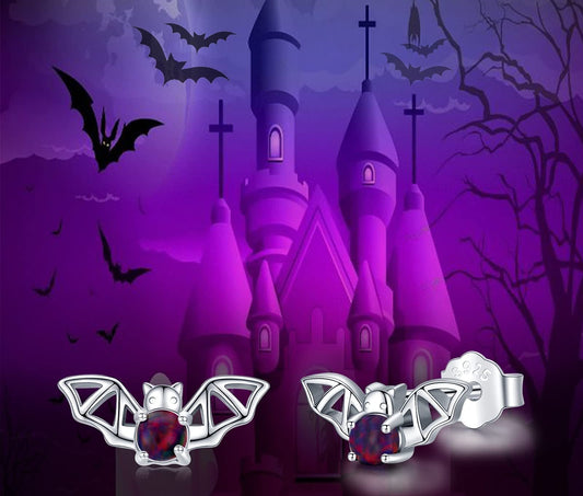Bat earrings with a Halloween-themed castle and bats in the background