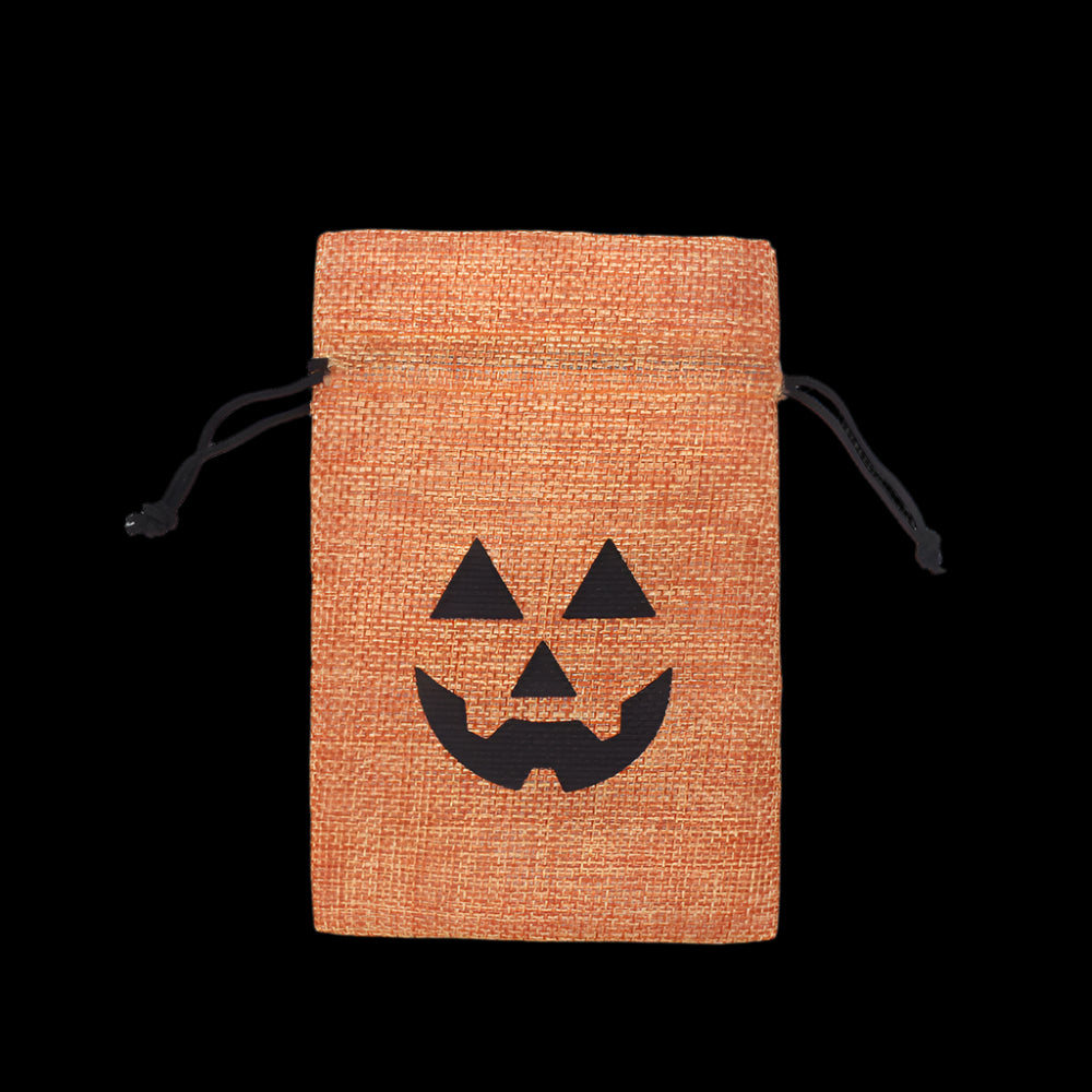 Hessian drawstring bag with a pumpkin face cutout on a white background