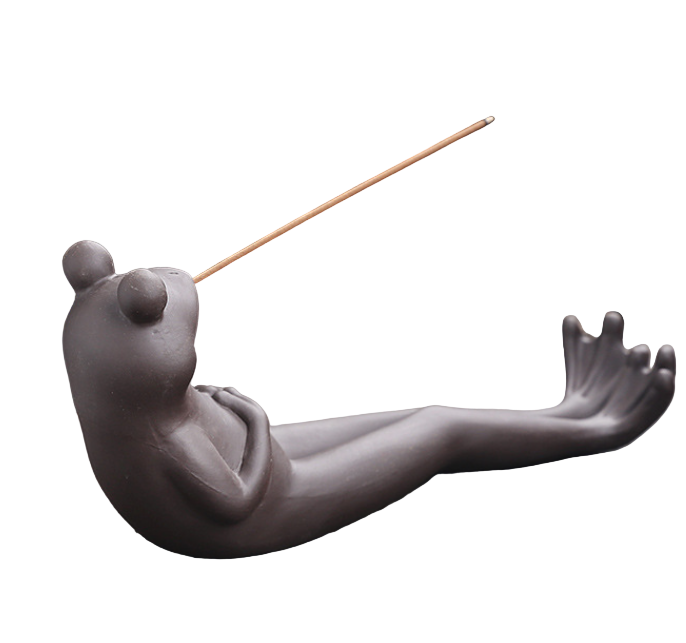 Ceramic snail-shaped incense holder with incense on a wooden surface