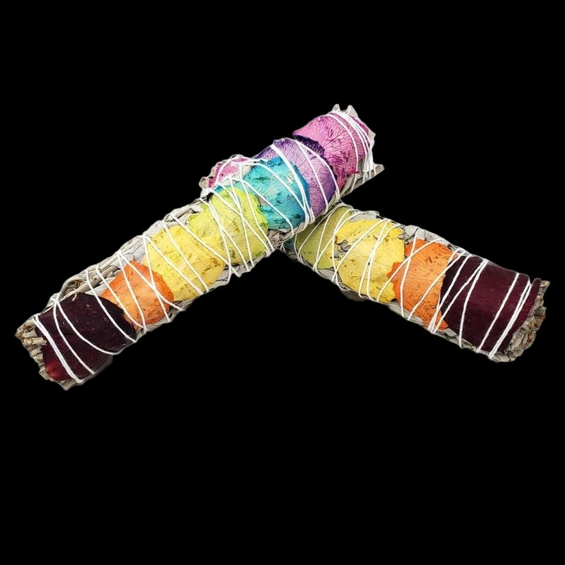 Colorful smudge sticks arranged in a U shape on a white background