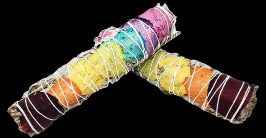 Colorful smudge sticks arranged in a U shape on a white background
