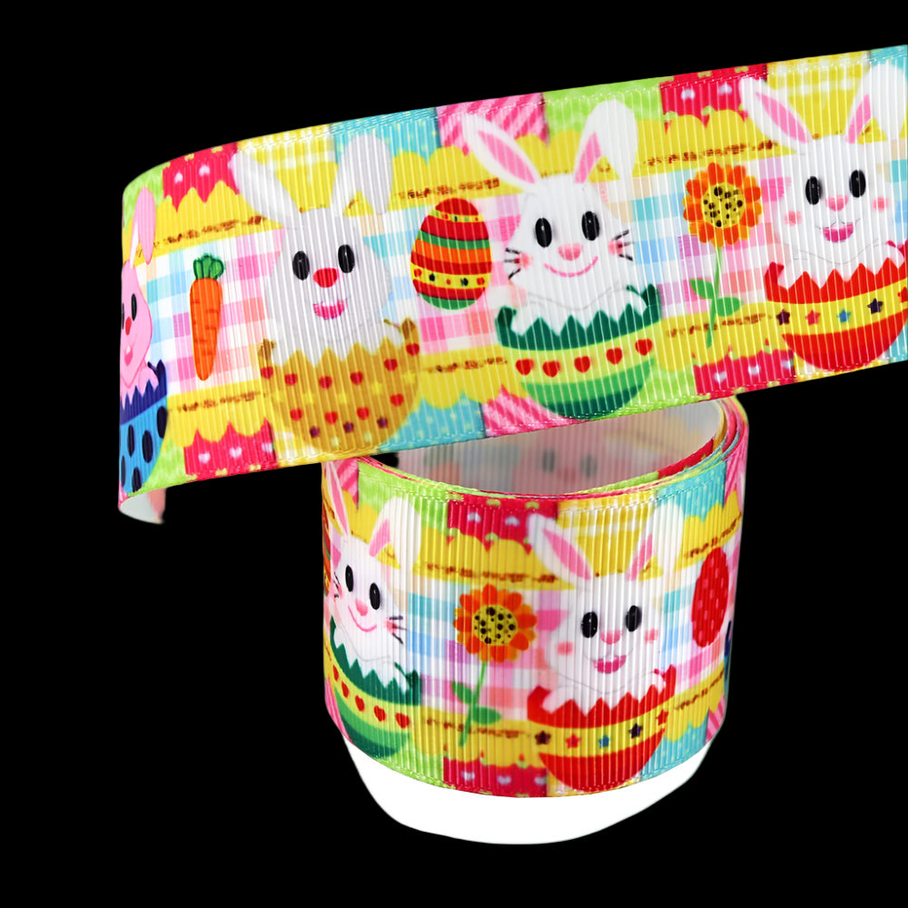 Colorful ribbon with Easter-themed design featuring bunnies, eggs, and carrots on a white background.