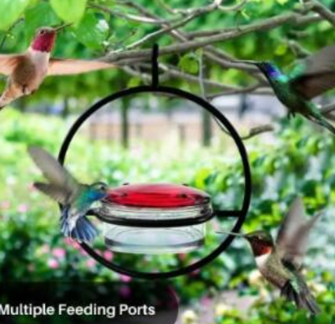 Hummingbird feeder with multiple feeding ports surrounded by hummingbirds in a garden setting.