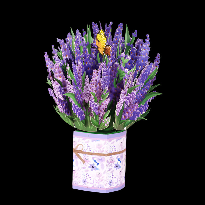 Bouquet of purple flowers in a decorative container on a pink background