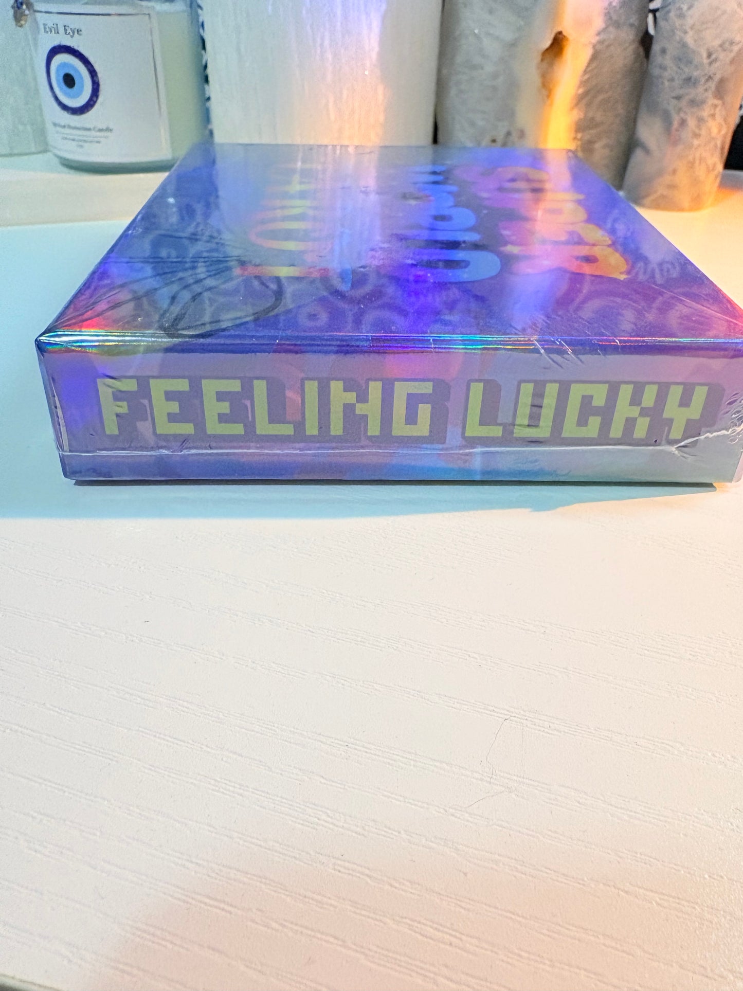 Iridescent book titled 'Feeling Lucky' on a white surface