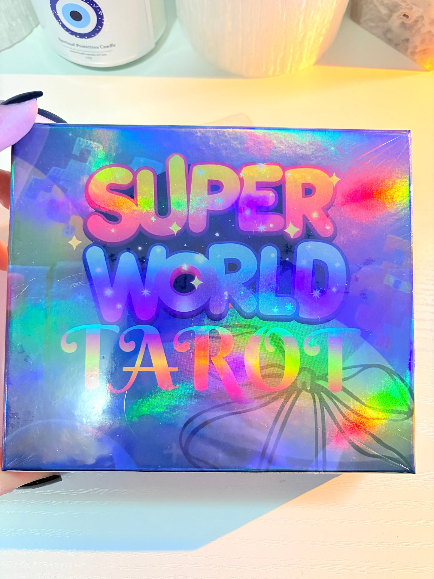 Holographic box with 'Super World Tour' text held by a hand
