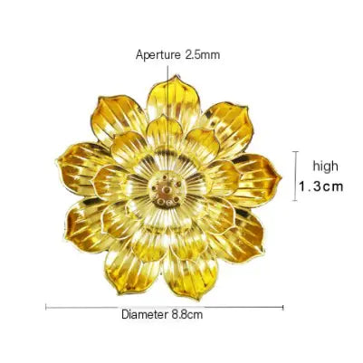 Gold flower-shaped object with measurements on a white background