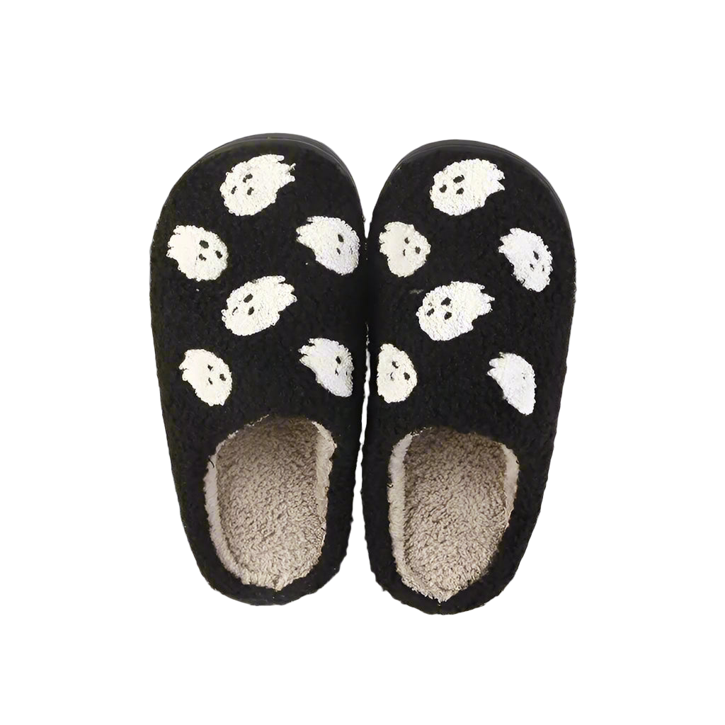 Pair of black slippers with white flower patterns on a light gray background