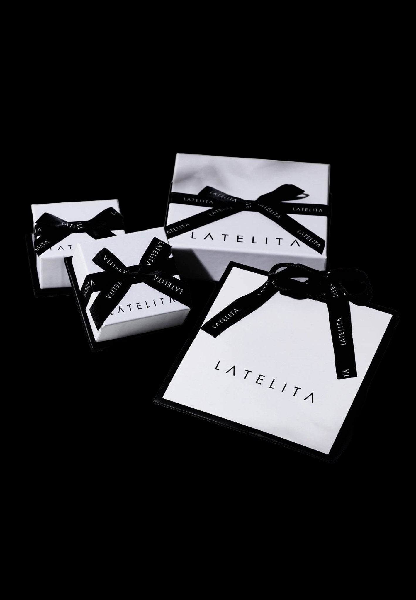 LATELITA boxes with black ribbons on a light background