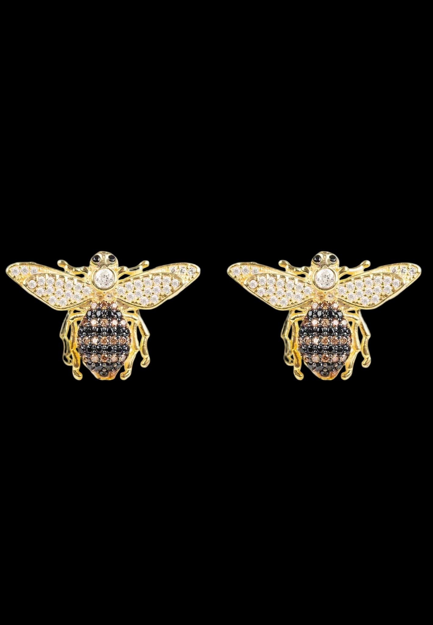Gold bee-shaped earrings with black gemstones on a white background