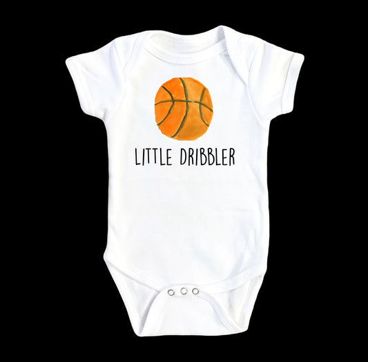 White baby onesie with a basketball graphic and 'Little Dribbler' text on a white background