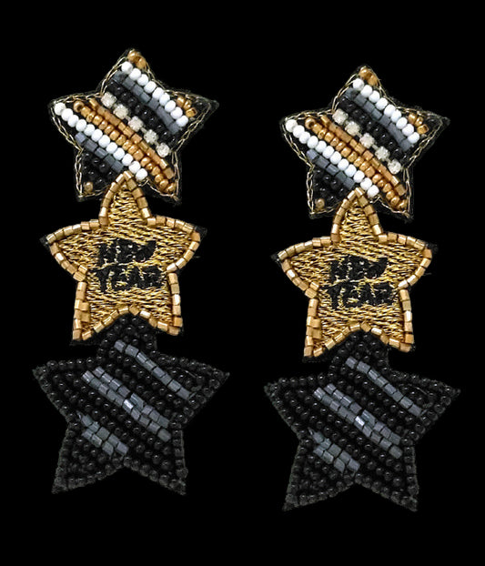 Star-shaped earrings with black, gold, and white beads on a white background