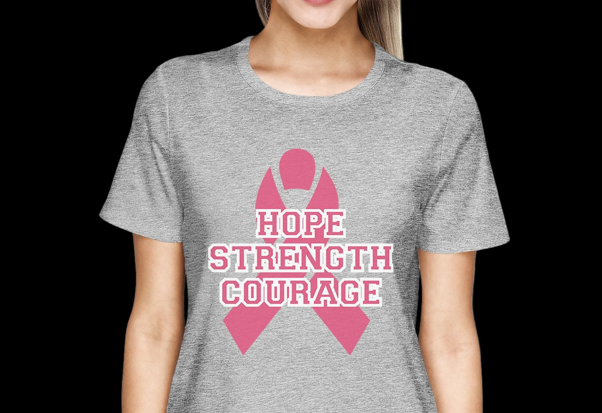 Person wearing a gray t-shirt with a pink ribbon and 'Hope Strength Courage' text on a white background