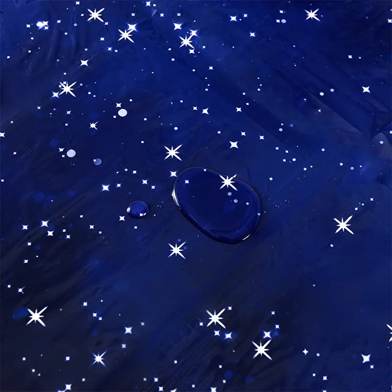 Blue water droplet with star-shaped reflections on a blue textured background