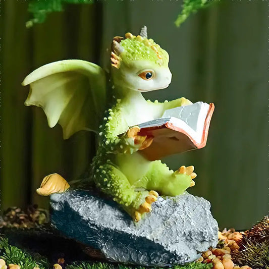 Green dragon figurine reading a book on a rock with a green background