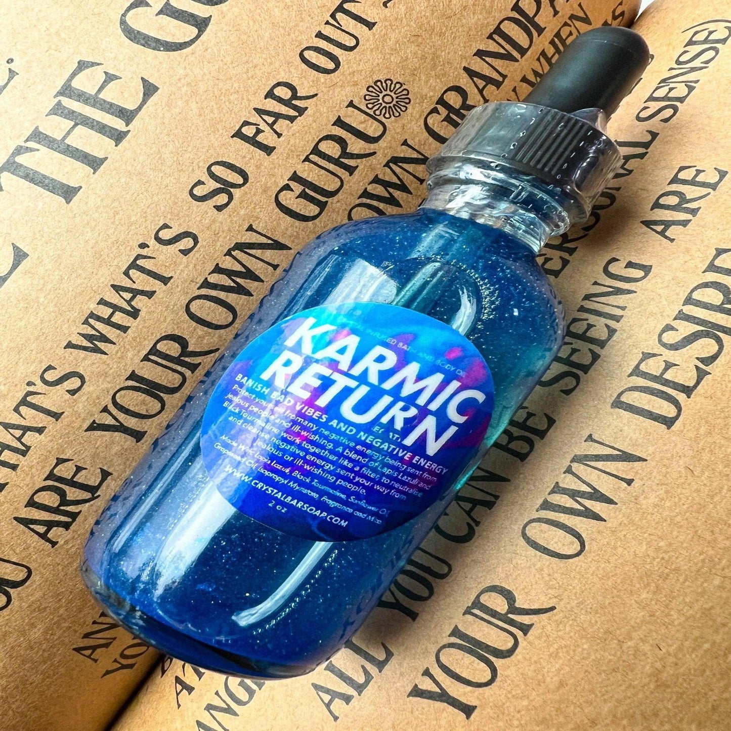 Blue bottle labeled 'Karmic Return' on a textured background