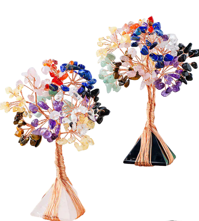Colorful crystal trees on a clear stand with a neutral background