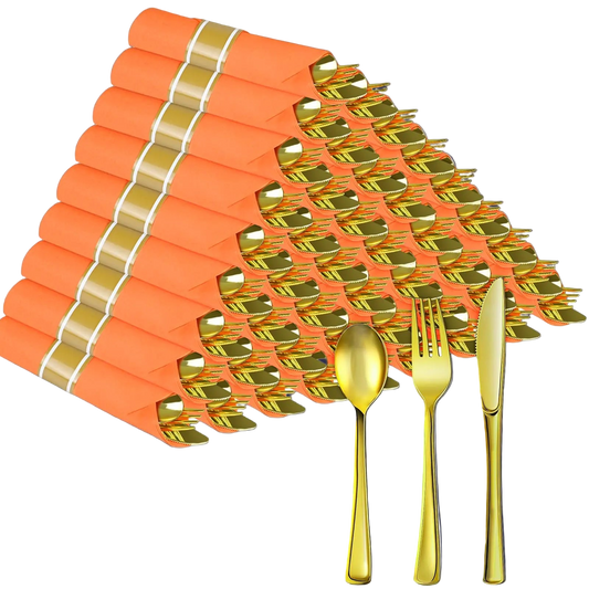Gold cutlery set with orange napkins on a white background