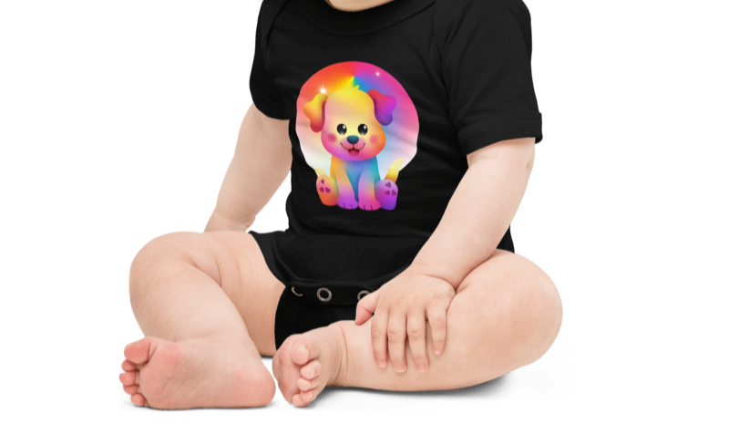 Baby wearing a black onesie with a colorful dog graphic on a white background